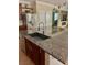 Kitchen island with granite countertops, modern sink fixtures, and stainless steel dishwasher at 5627 Spanish Valor Rd, Las Vegas, NV 89135