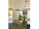Kitchen area featuring modern lighting fixtures and stainless steel appliances at 5627 Spanish Valor Rd, Las Vegas, NV 89135