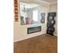 Open living area with fireplace, decorative shelving, and views into the dining room at 5627 Spanish Valor Rd, Las Vegas, NV 89135