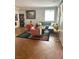Living room with a black leather couch, colorful pillows, and unique orange chairs at 5627 Spanish Valor Rd, Las Vegas, NV 89135