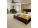 Spacious main bedroom with floral bedding, ceiling fan, office desk, and plenty of natural light from bright windows at 5627 Spanish Valor Rd, Las Vegas, NV 89135