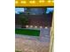 View of the backyard patio with a charming tree and landscape lighting, creating a peaceful outdoor ambiance at 5627 Spanish Valor Rd, Las Vegas, NV 89135