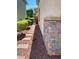 Landscaped side yard with stone pathway leading to a gate, adjacent to the home's exterior at 5627 Spanish Valor Rd, Las Vegas, NV 89135