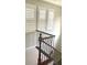A stairway features plantation shutters on three windows bringing natural light to the carpeted stairway at 5627 Spanish Valor Rd, Las Vegas, NV 89135
