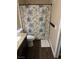 Cozy bathroom featuring a decorative shower curtain and wood look tile at 5710 E Tropicana Ave # 1053, Las Vegas, NV 89122