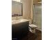 Bathroom featuring a sleek vanity with a solid countertop and a glass-enclosed shower at 5710 E Tropicana Ave # 1053, Las Vegas, NV 89122