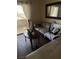 Relax in this comfy living room featuring wood floors, a plush sofa, and access to a balcony with great views at 5710 E Tropicana Ave # 1053, Las Vegas, NV 89122
