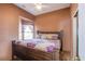 Cozy bedroom features a high ceiling, ceiling fan, and a window with natural light at 6274 Elderberry Wine Ave, Las Vegas, NV 89142