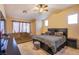 Large main bedroom with vaulted ceilings, ceiling fan, couch, and ensuite bath at 6274 Elderberry Wine Ave, Las Vegas, NV 89142