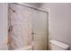 Bathroom with a modern shower and stylish marble-patterned tile surround at 6274 Elderberry Wine Ave, Las Vegas, NV 89142