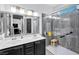 Modern bathroom featuring double sinks, stylish lighting, and a sleek glass-enclosed shower at 6324 Desert Leaf St # 3, North Las Vegas, NV 89081