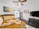 Cozy bedroom featuring a ceiling fan, plush bed, and natural light at 6324 Desert Leaf St # 3, North Las Vegas, NV 89081