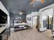 This primary bedroom has a large bed with dark grey walls and leads into a bathroom at 6324 Desert Leaf St # 3, North Las Vegas, NV 89081
