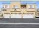 Townhouse exterior featuring multi-car garages and clean lines at 6324 Desert Leaf St # 3, North Las Vegas, NV 89081