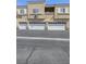 Exterior townhome showcasing attached garages and stucco facade at 6324 Desert Leaf St # 3, North Las Vegas, NV 89081