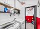 Efficient laundry room with modern washer, dryer, and upper cabinets for ample storage at 6324 Desert Leaf St # 3, North Las Vegas, NV 89081