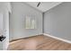 Bedroom featuring light wood floors, gray accent wall, and a ceiling fan at 6664 Rutgers Dr, Las Vegas, NV 89156