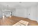 Open dining room with hardwood flooring, a modern light fixture, and easy access to the kitchen at 6664 Rutgers Dr, Las Vegas, NV 89156