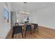 Bright dining room with hardwood floors, a modern chandelier, and views of the kitchen at 6664 Rutgers Dr, Las Vegas, NV 89156