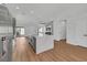 Open kitchen with stainless steel appliances, hardwood flooring, a white island, and sliding glass doors at 6664 Rutgers Dr, Las Vegas, NV 89156