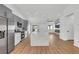 Bright kitchen boasts a waterfall island, stainless steel appliances, and gray and white cabinetry at 6664 Rutgers Dr, Las Vegas, NV 89156