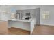 Modern kitchen with large island, stainless steel appliances, and gray cabinets, perfect for entertaining at 6664 Rutgers Dr, Las Vegas, NV 89156