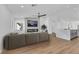 Modern living room with hardwood floors, a gray sofa, and a contemporary fireplace with a TV at 6664 Rutgers Dr, Las Vegas, NV 89156