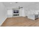 Spacious living room with hardwood flooring and a contemporary fireplace with a TV above at 6664 Rutgers Dr, Las Vegas, NV 89156