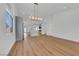 Bright, open-concept living room with modern lighting and wood-look flooring throughout at 6664 Rutgers Dr, Las Vegas, NV 89156