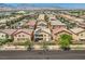 Backyard view of homes with solar panels and the neighborhood landscape at 6750 Quapaw St, Las Vegas, NV 89149
