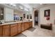 Bathroom features a large vanity with dual sinks, tile floors, and ample storage at 6750 Quapaw St, Las Vegas, NV 89149