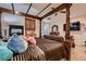 Bedroom featuring a canopy bed with decorative wood trim, fireplace and matching furniture at 6750 Quapaw St, Las Vegas, NV 89149