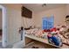 Bedroom features a window with blinds, carpet and mounted TV at 6750 Quapaw St, Las Vegas, NV 89149