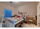 Bright bedroom features a window with blinds, carpet and desk with vanity at 6750 Quapaw St, Las Vegas, NV 89149