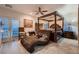 Bedroom with ceiling fan, a plush chaise lounge, and French doors leading to a balcony at 6750 Quapaw St, Las Vegas, NV 89149