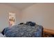 Bedroom featuring a dark comforter, carpet and doorway to closet at 6750 Quapaw St, Las Vegas, NV 89149