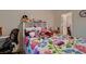 Bedroom features a floral comforter, carpet and doorway to closet at 6750 Quapaw St, Las Vegas, NV 89149