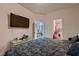 Comfortable bedroom featuring a TV, glass table and a paisley comforter with walk-in closet at 6750 Quapaw St, Las Vegas, NV 89149
