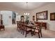Dining room with a formal table set for ten, traditional decor, and carpet flooring at 6750 Quapaw St, Las Vegas, NV 89149