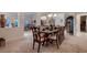 Spacious dining room featuring a large table with ten chairs with views into living areas at 6750 Quapaw St, Las Vegas, NV 89149