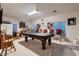 Spacious game room featuring a pool table, bar, and ample seating for entertaining at 6750 Quapaw St, Las Vegas, NV 89149