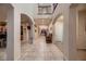 Grand hallway showcasing high ceilings, arched doorways, and neutral tile flooring at 6750 Quapaw St, Las Vegas, NV 89149