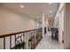 Second floor hallway featuring wood floors, iron railings, and lots of natural light at 6750 Quapaw St, Las Vegas, NV 89149