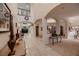 Spacious hallway with tile flooring, arched doorways, and view of the upper level at 6750 Quapaw St, Las Vegas, NV 89149