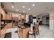 Large kitchen featuring an island with bar seating, maple cabinets, and stainless appliances at 6750 Quapaw St, Las Vegas, NV 89149