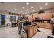 Open-concept kitchen featuring a breakfast bar, stainless steel appliances, and neutral tiling at 6750 Quapaw St, Las Vegas, NV 89149