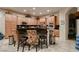 Kitchen featuring maple cabinets, granite countertops, and a central island with seating at 6750 Quapaw St, Las Vegas, NV 89149