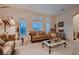 Cozy living room offering plush sofas, carpet flooring and traditional decor at 6750 Quapaw St, Las Vegas, NV 89149