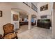 Spacious living room with tile flooring, arched doorways, and decorative accents at 6750 Quapaw St, Las Vegas, NV 89149