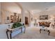 Open-concept living room showcasing plush sofas, carpet flooring, and ornate decor at 6750 Quapaw St, Las Vegas, NV 89149